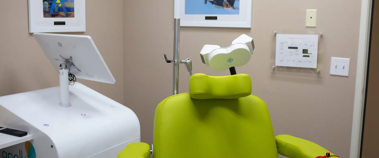 TMS treatment room at Karma TMS with the Apollo TMS device and patient chair